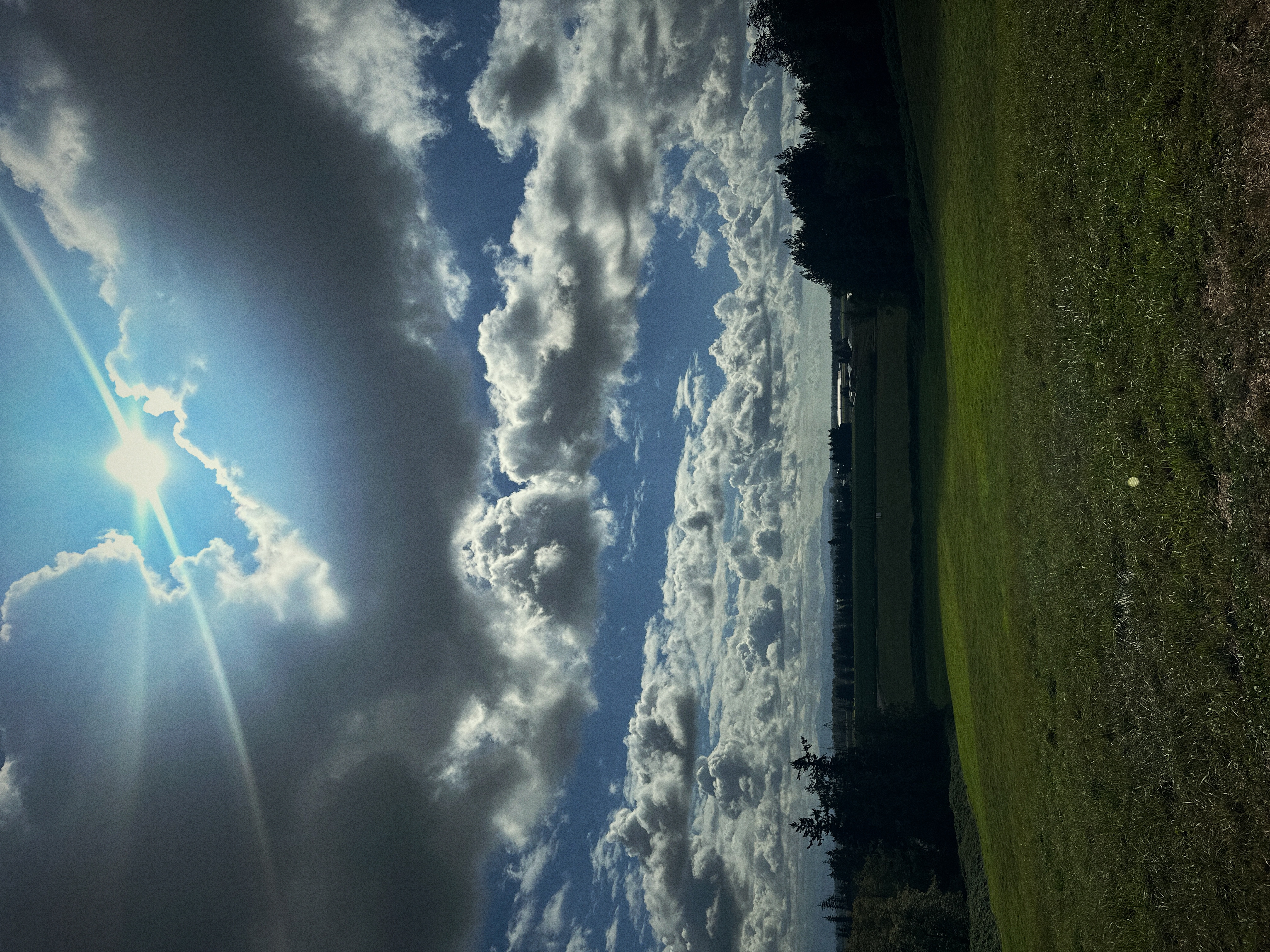 Sun breaking through over the field